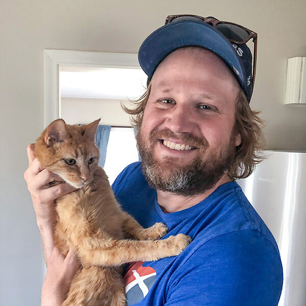 dog-and-duties-josh A smiling man is holding a cat.